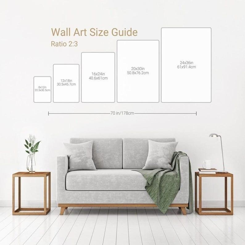 May include: A wall art size guide with the text "Wall Art Size Guide Ratio 2:3". The guide shows five rectangular art sizes: 8x12in, 12x18in, 16x24in, 20x30in, and 24x36in. A sofa and side tables are in the foreground.