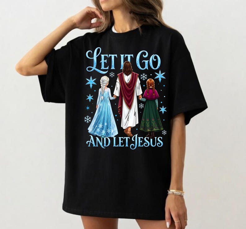 May include: Black t-shirt with the text "Let It Go and Let Jesus" in blue script. The graphic features three figures: Jesus, and two characters in blue and green dresses. Snowflakes are scattered around the figures.