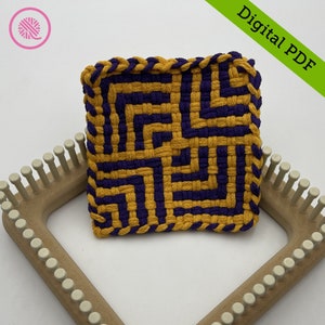 May include: A loom with a woven square made with purple and gold yarn. The square is on the loom and the loom is on a white surface. The text "Digital PDF" is in the upper right corner of the image.