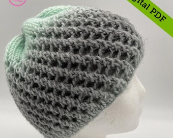 May include: A gray and green ombre crochet beanie hat with a textured stitch pattern. The hat is on a white mannequin head.