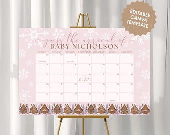 May include: A pink baby shower calendar with the text "guess the arrival of BABY NICHOLSON". The calendar features a snowflake design and gingerbread house border. The calendar is displayed on a gold easel.