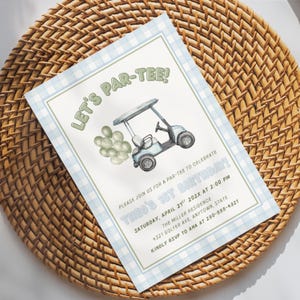May include: A rectangular birthday invitation card with a light blue gingham border. The card features a golf cart illustration, a cluster of sage green balloons, and the text: LET'S PAR-TEE! PLEASE JOIN US FOR A PAR-TEE TO CELEBRATE THEO'S 1ST BIRTHDAY.