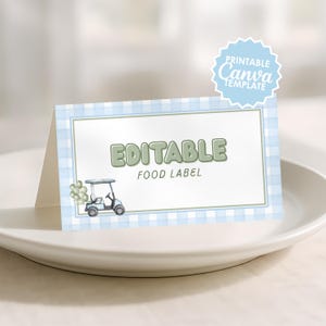 May include: A folded paper food label featuring a light blue and white gingham pattern border. The centre displays the green text EDITABLE FOOD LABEL and a small illustration of a golf cart with green balloons. A blue badge reads PRINTABLE Canva TEMPLATE.