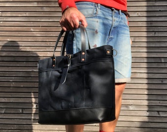 Black tote bag in waxed canvas with leather bottom and cross body strap