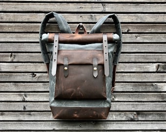 Waxed canvas backpack with roll up top and hand waxed  leather bottom and outside pocket COLLECTION UNISEX