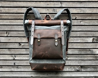 Waxed canvas backpack with roll up top and hand waxed  leather bottom and outside pocket COLLECTION UNISEX