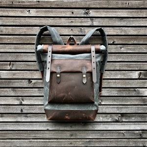 Waxed canvas backpack with roll up top and hand waxed  leather bottom and outside pocket COLLECTION UNISEX