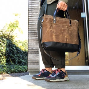 Office tote bag in waxed canvas with luggage handle attachment leather handles and shoulder strap