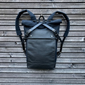 Black backpack medium size rucksack in waxed canvas, with leather front pocket and bottom image 1