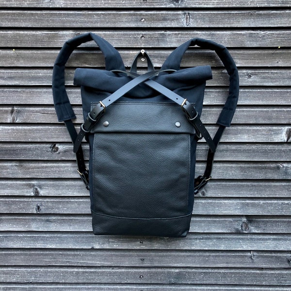 Black backpack medium size rucksack in waxed canvas, with leather front pocket and bottom