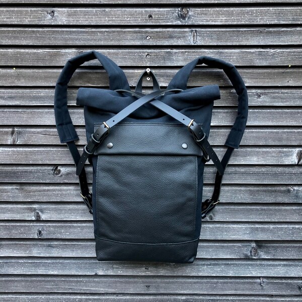 Black backpack medium size rucksack in waxed canvas, with leather front pocket and bottom