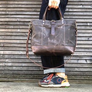 Waxed canvas tote bag with leather handles and shoulder strap