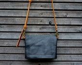 Handbag / clutch in waxed canvas with fold over top in leather   / satchel in black leather