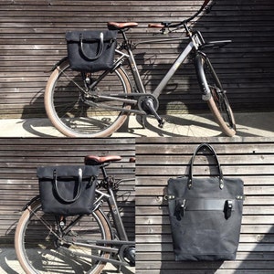 Black bike pannier tote bag in waxed canvas with zipper closure and cross body strap