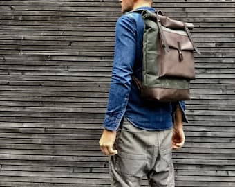 Waxed canvas backpack with roll to close top with leather bottom and outside pocket