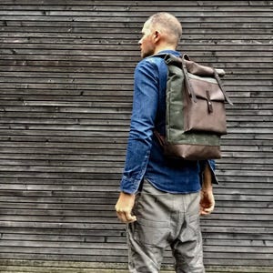 Waxed canvas backpack with roll to close top with leather bottom and outside pocket