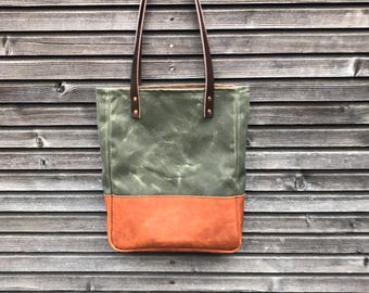 waxed canvas tote bag with leather base and zipper pocket inside
