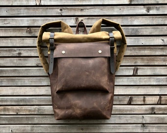 Leather backpack with waxed canvas  roll to close top and leather front pocket