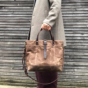 Tote bag made in brush brown waxed canvas with leather bottom and cross body strap