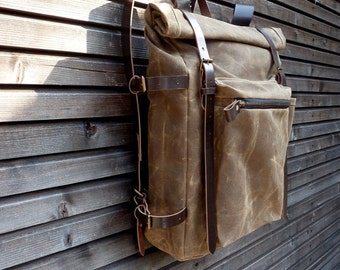 Outdoor waxed canvas backpack with roll to close top and vegetable tanned leather shoulder straps