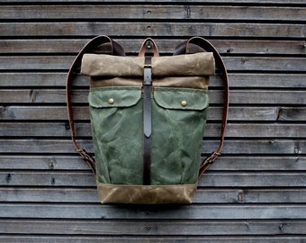Waxed canvas backpack with roll to close top and vegetable tanned leather shoulderstrap and back reinforcement