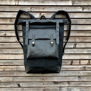 Rucksack made in black waxed canvas  with roll top and  leather bottem COLLECTION UNISEX