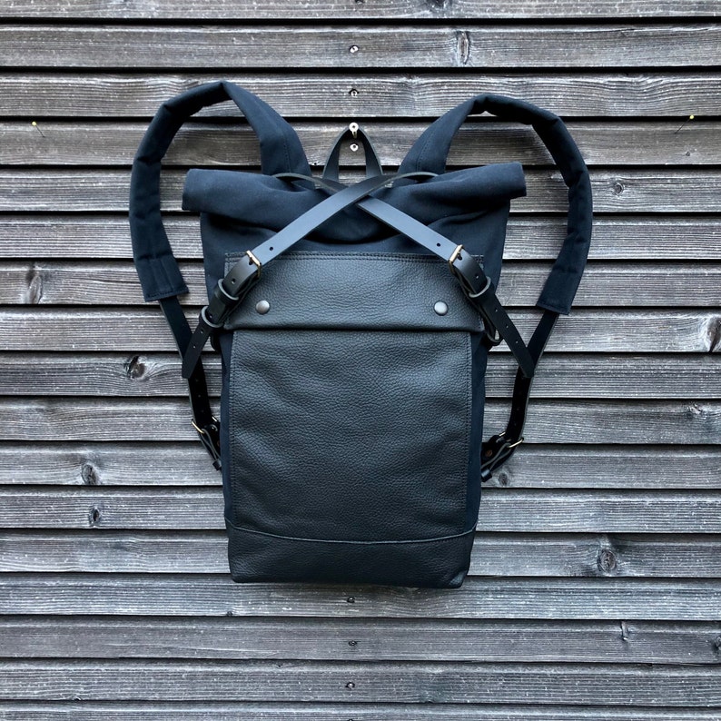 Black backpack medium size rucksack in waxed canvas, with leather front pocket and bottom image 1
