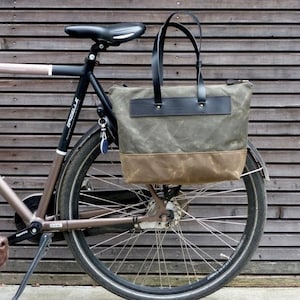 pannier bag made in olive and field tan waxed canvas with black leather attachment and leather shoulder straps