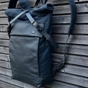 Black backpack medium size rucksack in waxed canvas, with leather front pocket and bottom image 3