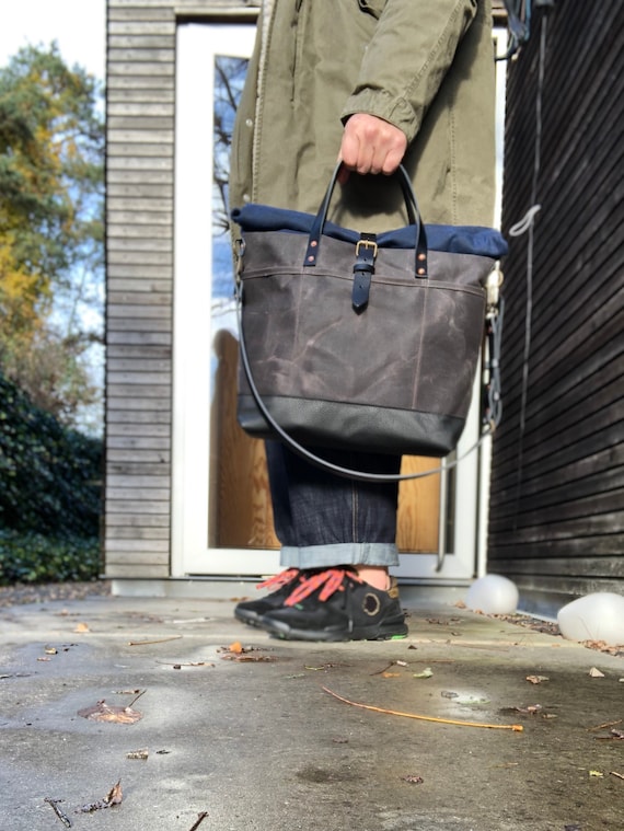 Waxed canvas roll top tote bag with luggage handle attachment