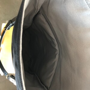 Black backpack medium size rucksack in waxed canvas, with leather front pocket and bottom image 6