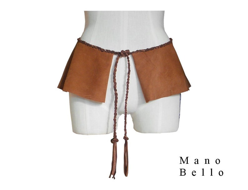 May include: A brown leather belt with a braided design and long tassels. The belt is tied around a white form and has two flaps of leather on either side.
