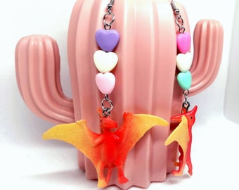 Dinosaur earrings! Handmade, with heart-shaped beads. Pterodactyl