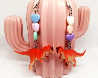 Dinosaur earrings! Handmade, with heart-shaped beads. Orange dinosaur