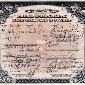 May include: An antique prescription blank from the National Prohibition Act, featuring handwritten details and floral border accents. The document includes text such as "Prescription Blank" and "For Use of Druggist or Pharmacist Only."