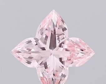 May include: A light pink, flower-shaped gemstone with multiple facets. The gemstone has a four-petal design, with each petal pointed and triangular. The gem is set against a light gray background.