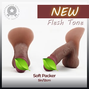 May include: A medical grade silicone soft packer in a flesh tone, shown from front and side angles. The product features a realistic texture and measures 5 inches. Text on the image includes NEW, Flesh Tone, and Soft Packer 5in/12cm.