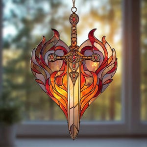 May include: Stained glass suncatcher featuring a sword design with a heart-shaped flame motif. The sword has a detailed hilt and is adorned with red accents. The flames are in shades of orange, red, and yellow, creating a vibrant and eye-catching piece.