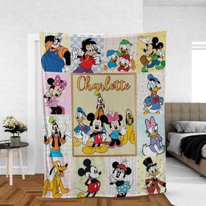 May include: A fleece blanket featuring a patchwork design of various Disney characters including Mickey Mouse, Minnie Mouse, Donald Duck, Daisy Duck, Goofy, and Pluto. The center panel displays the name Charlotte in a cursive orange font.