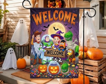 May include: A rectangular garden flag featuring Toy Story characters dressed in Halloween costumes. The flag displays the text WELCOME in orange dripping letters at the top and WELCOME on a wooden sign held by the characters. The background is purple.