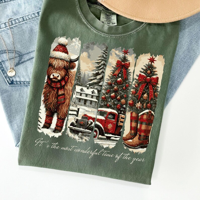 May include: Green t-shirt with a Christmas-themed graphic. The design includes a Highland cow in a Santa hat and scarf, a snowy scene with a red truck, Christmas trees, and cowboy boots. The text reads "It's the most wonderful time of the year."