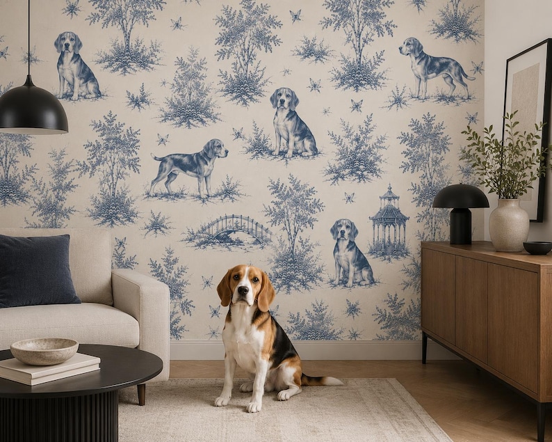 May include: Wallpaper featuring a blue and white toile pattern with illustrations of beagle dogs, trees, a bridge, and a gazebo. The design is printed on a light cream background, creating a repeating scene of nature and canine figures.