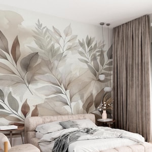 May include: A bedroom with a large mural of stylized leaves in brown, grey, and beige tones. The bed has a light pink headboard and is covered with white linens and a grey throw. A brown curtain hangs on the right side.