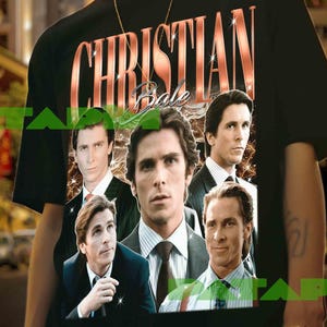 May include: Black t-shirt featuring the text "CHRISTIAN BALE" in a copper-colored font, with multiple images of the actor. The shirt is worn by a person in front of a blurred city background.