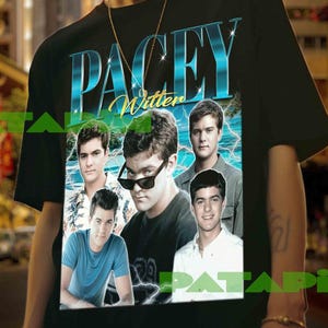 May include: Black t-shirt featuring a graphic design with the text "PACEY Witter" in blue and white, along with images of several men. The design has a vintage, retro style.