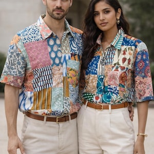May include: Two people in patchwork short-sleeved shirts with diverse patterns and colours, matched with beige trousers and brown belts. The shirts display floral, geometric, and abstract designs. One person holds sunglasses.