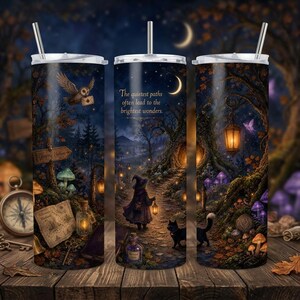 May include: A cylindrical tumbler with a straw featuring a dark forest scene at night, a person in a cloak holding a lantern, a black cat, glowing mushrooms, and the text: The quietest paths often lead to the brightest wonders. An owl flies above.