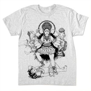 May include: A light grey t-shirt with a black and white illustration of a multi-armed deity standing on a figure. The deity is adorned with jewellery and holds various weapons. The design is detailed and intricate, with a circular halo.