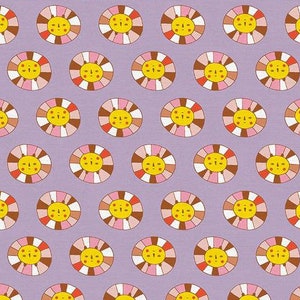 May include: A repeating pattern of colorful suns with smiling faces on a light purple background. Each sun has a yellow center, pink and brown rays, and a red mouth.