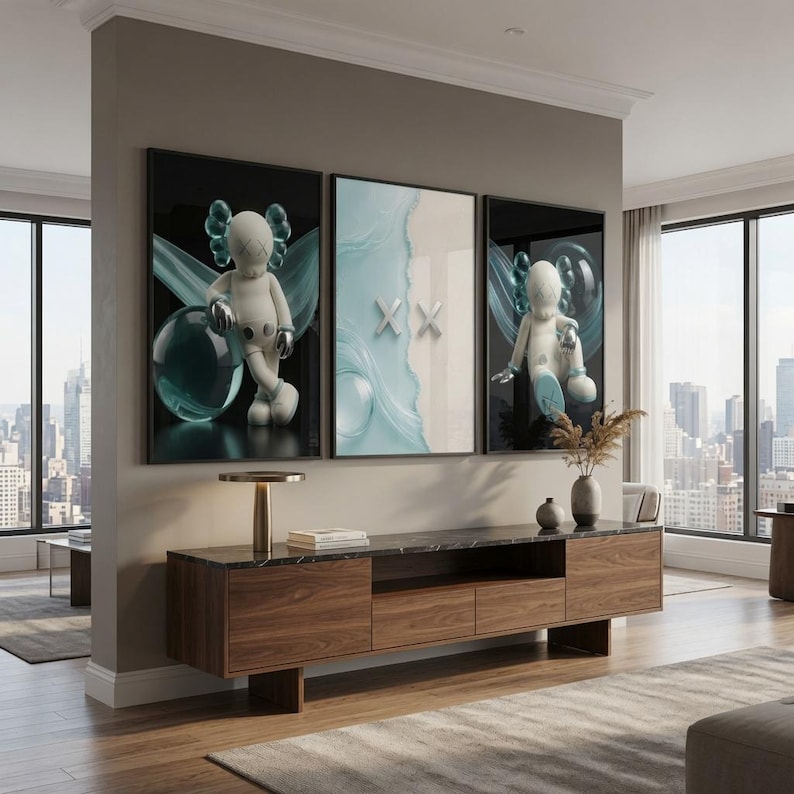 May include: A triptych wall art set featuring two outer panels with white cartoon figures against black backgrounds and a central panel with a light blue abstract wave design and two white X symbols, mounted above a long wooden media console.
